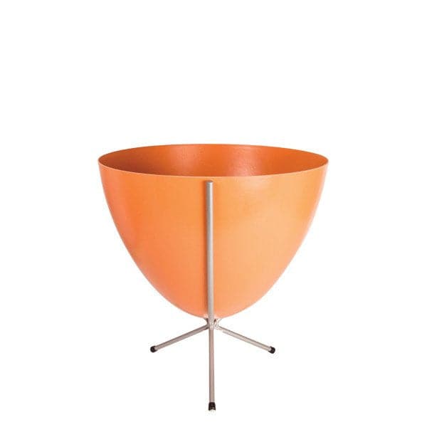 In front of white background is an orange colored planter in a short silver metal stand. The bullet planter is wide at the top and narrow at the bottom. The metal stand has three legs. 