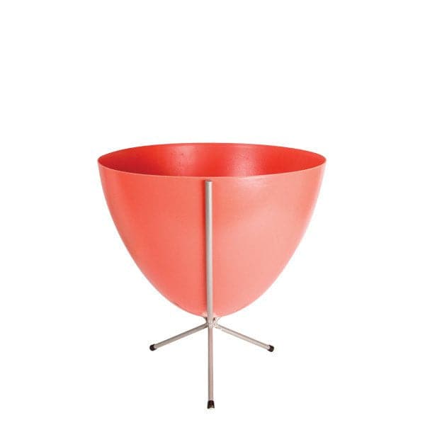 In front of white background is a red colored planter in a short silver metal stand. The bullet planter is wide at the top and narrow at the bottom. The metal stand has three legs. 
