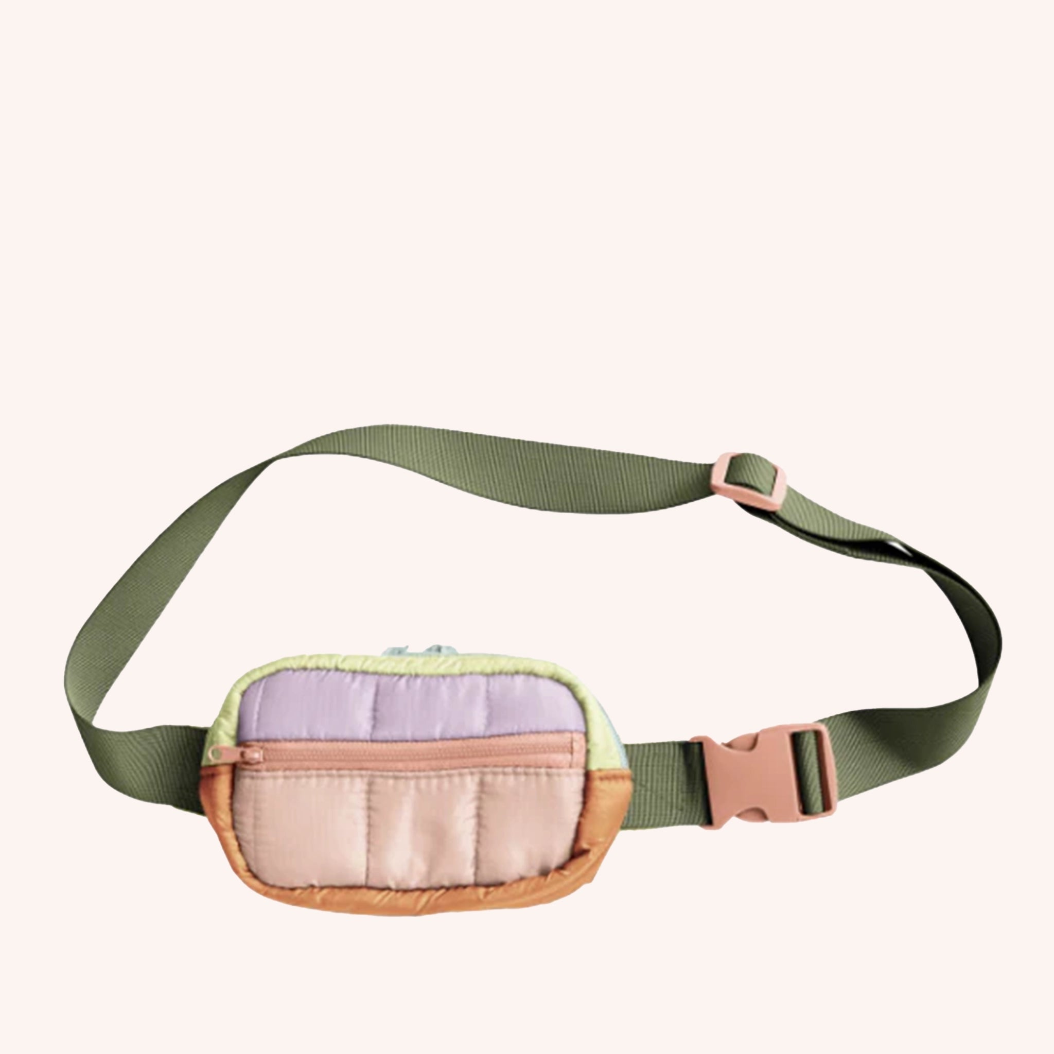 A crossbody bag or fanny pack with an adjustable olive green strap, and multiple pastel shaded color blocking. It features a puffy quilted material and also has two zipper pockets on the front.