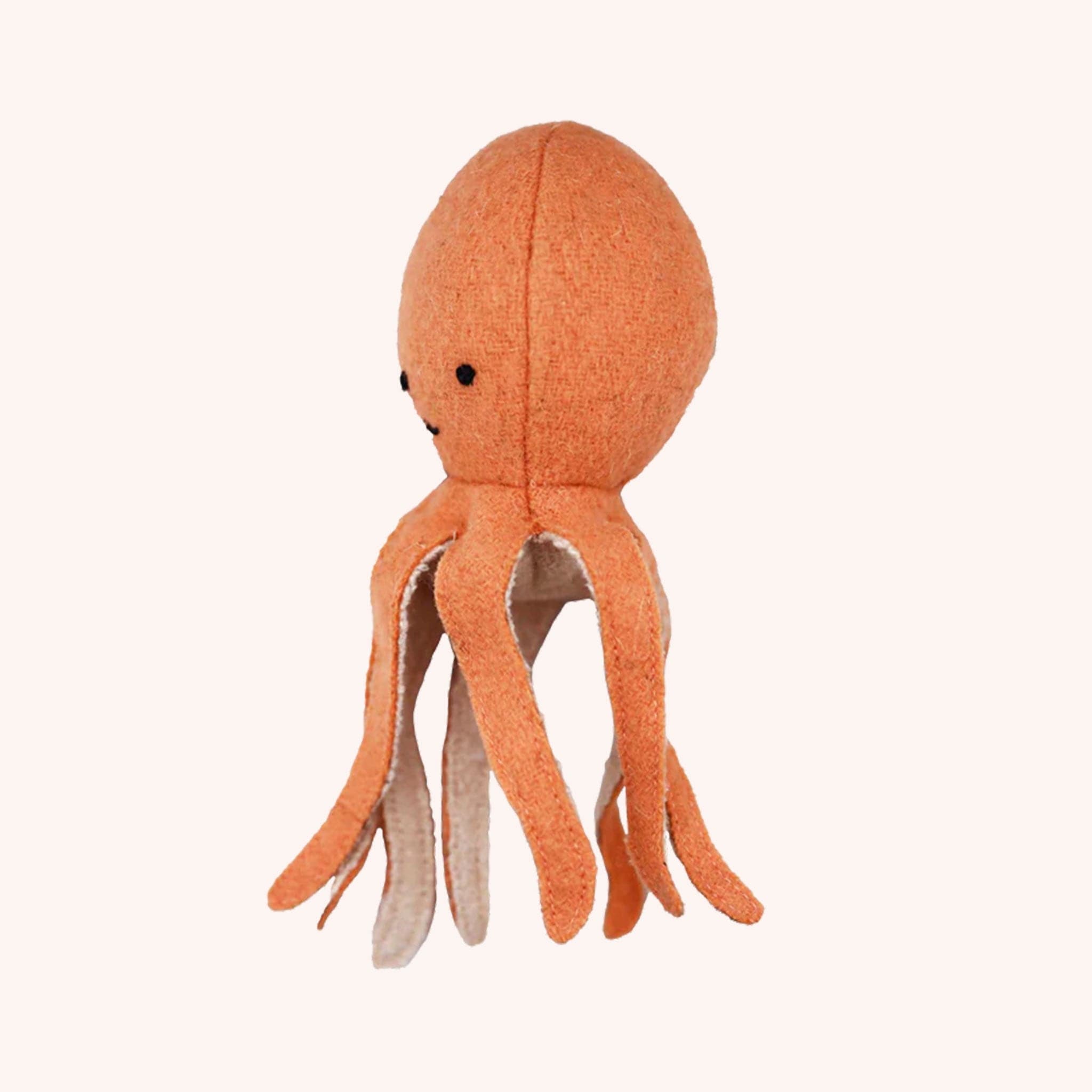 An orange octopus stuffed toy with eight dangling tentacles and a smiling face.