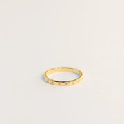 Delicate gold ring with etched suns and moons circling the band. Each sun and moon has a CZ gem in the center.