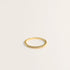 A delicate gold ring with a half pave design. This ring's band is thin, which is perfect for stacking.
