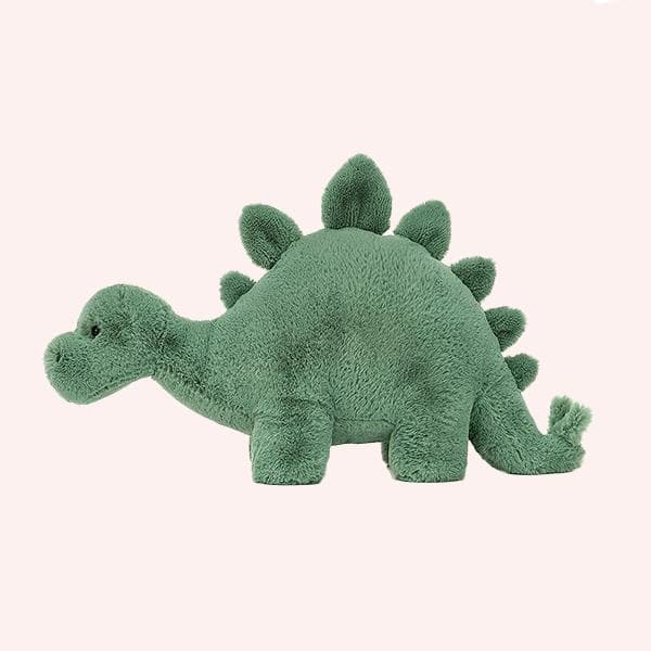 On a white background is a green stegosaurus stuffed animal.