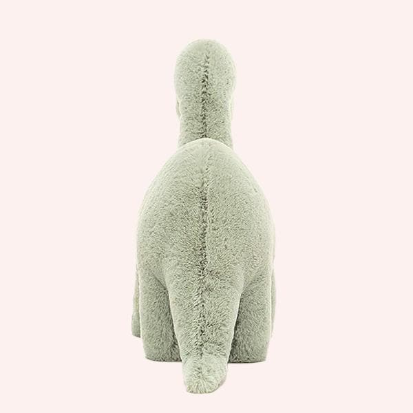 On a white background is a green brontosaurus stuffed animal.