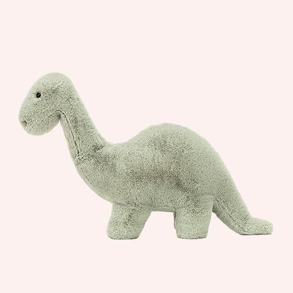 On a white background is a green brontosaurus stuffed animal.