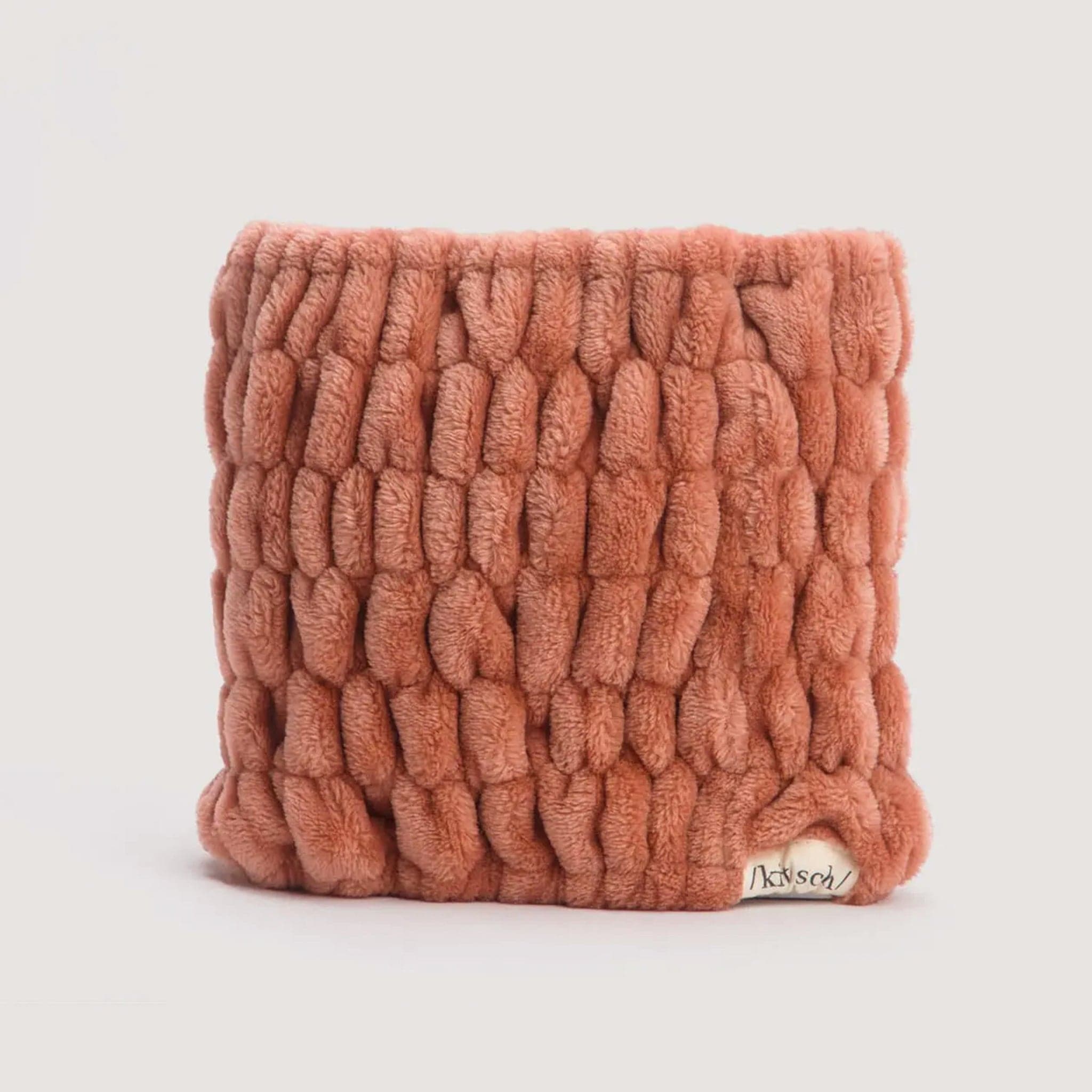Velvety soft, pale coral headband with a scrunched texture throughout. A small 'Kitch' label is stitched in the bottom right corner of the headband. 