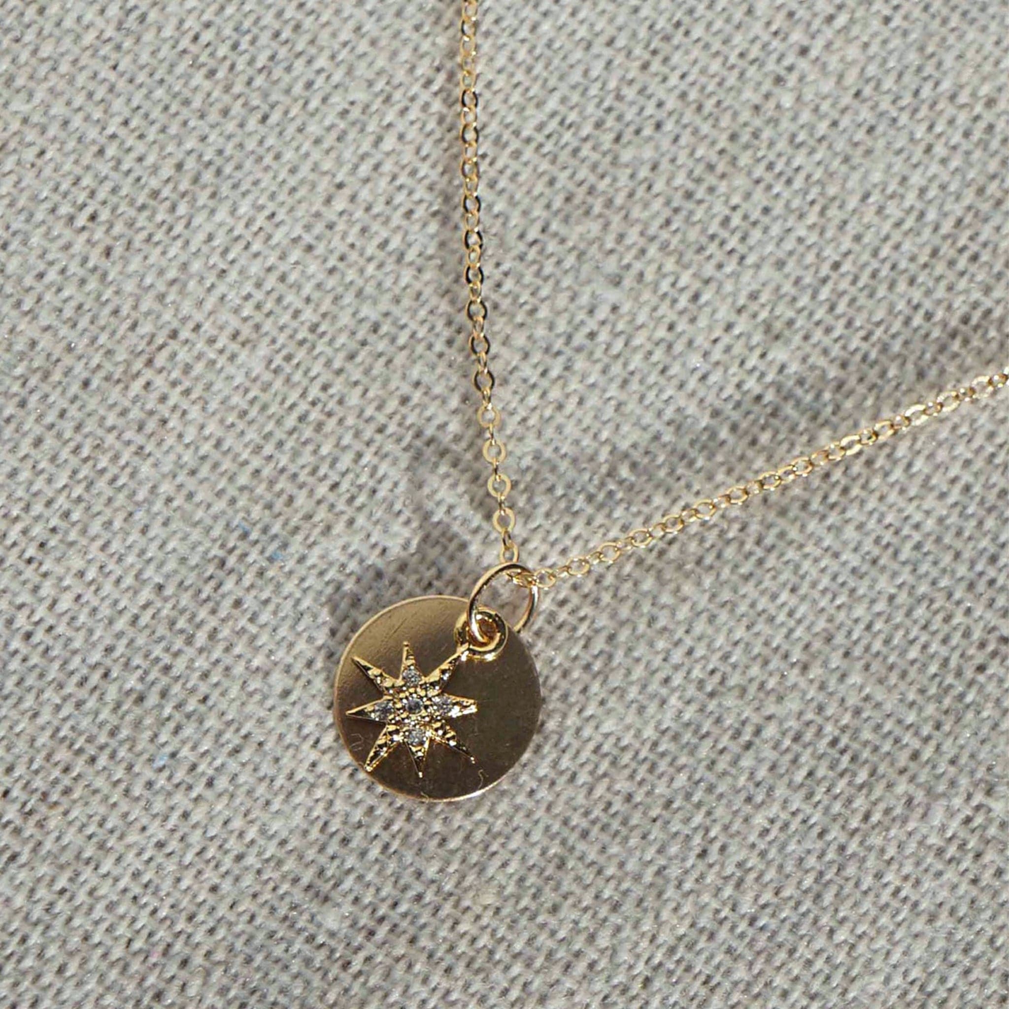 Long gold chain and circle gold pendant with crystal gemmed star charm.
