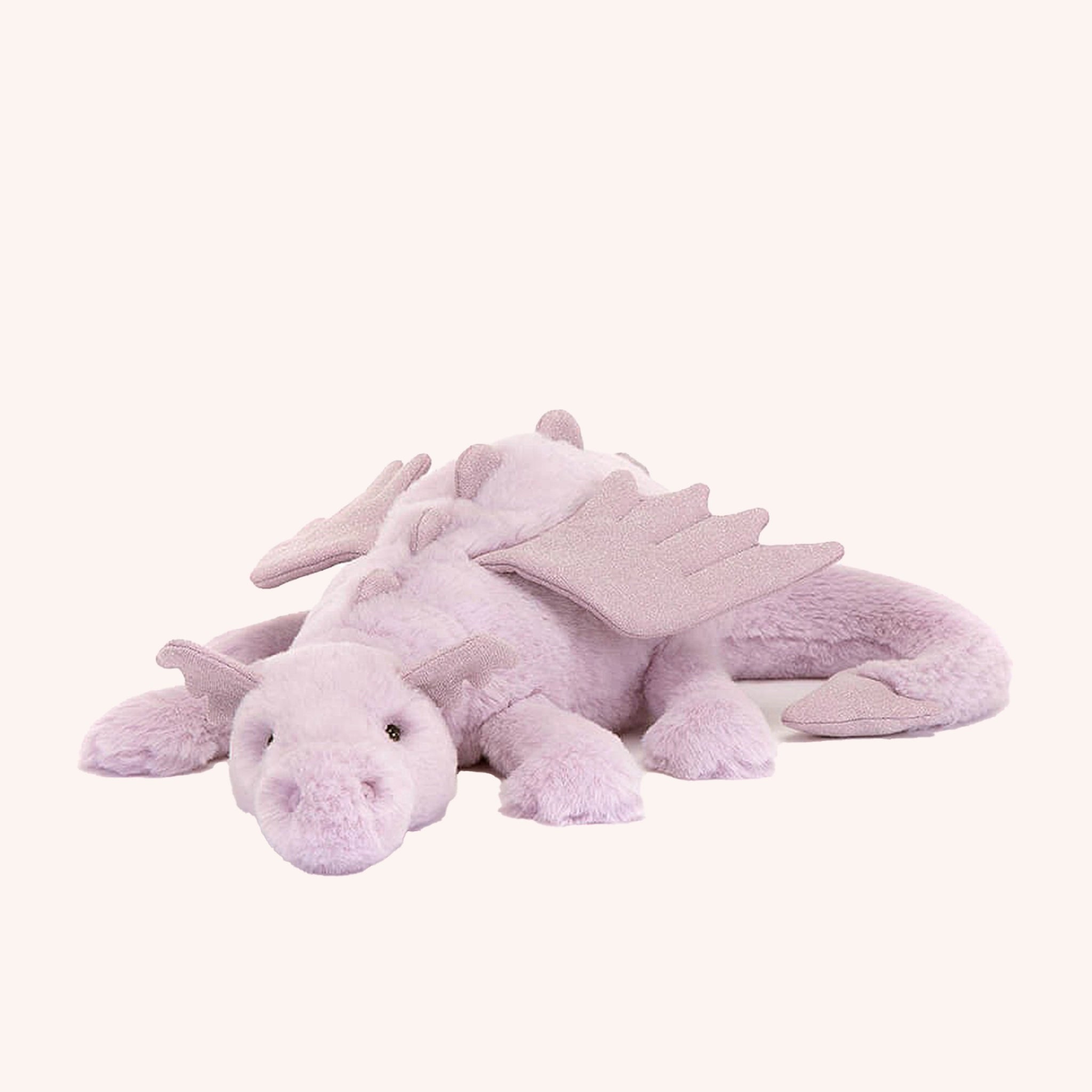 On a white background is a light purple dragon stuffed animal with wings, a sweet face and a long tail.