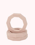 A decagon ring shaped rubber dog toy in light peachy color.