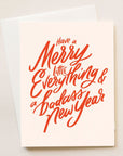 A light blush card with red writing that reads, "Have a Merry Little Everything & a badass New Year".