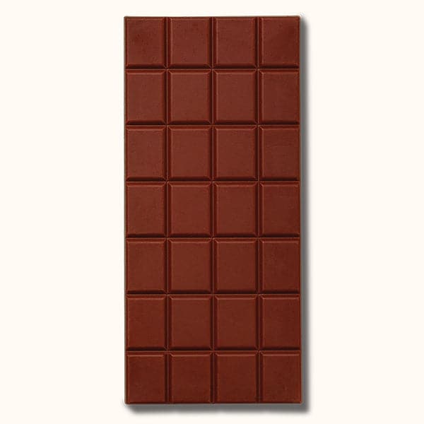 A rectangular bar of chocolate that read, "Mast Milk Chocolate" at the top in black letters along with a two toned wrapper that is brown and white unwrapped in this photo to show the rectangular scoring.