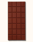 A rectangular bar of chocolate that read, "Mast Milk Chocolate" at the top in black letters along with a two toned wrapper that is brown and white unwrapped in this photo to show the rectangular scoring.