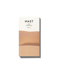 A rectangular bar of chocolate that read, "Mast Milk Chocolate" at the top in black letters along with a two toned wrapper that is brown and white.
