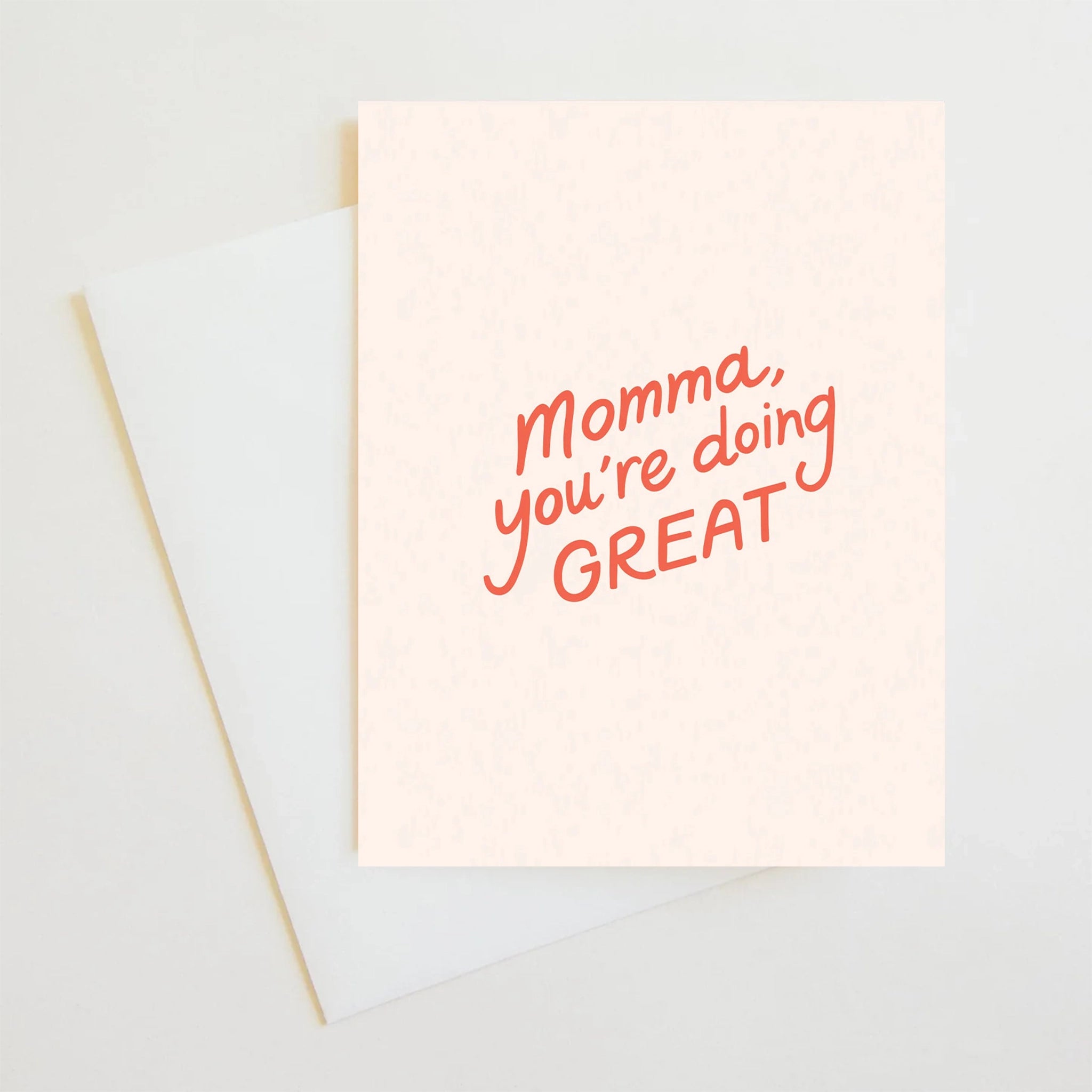 On a white background is a light ivory card that reads, "Momma, you're doing GREAT" in red letters. 