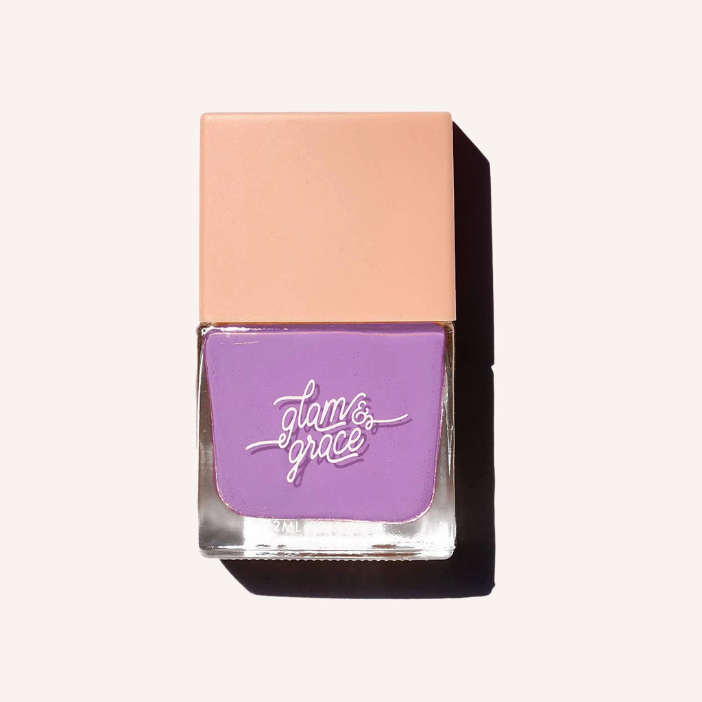 A bright purple satin nail polish in a glass bottle with a peachy square lid.