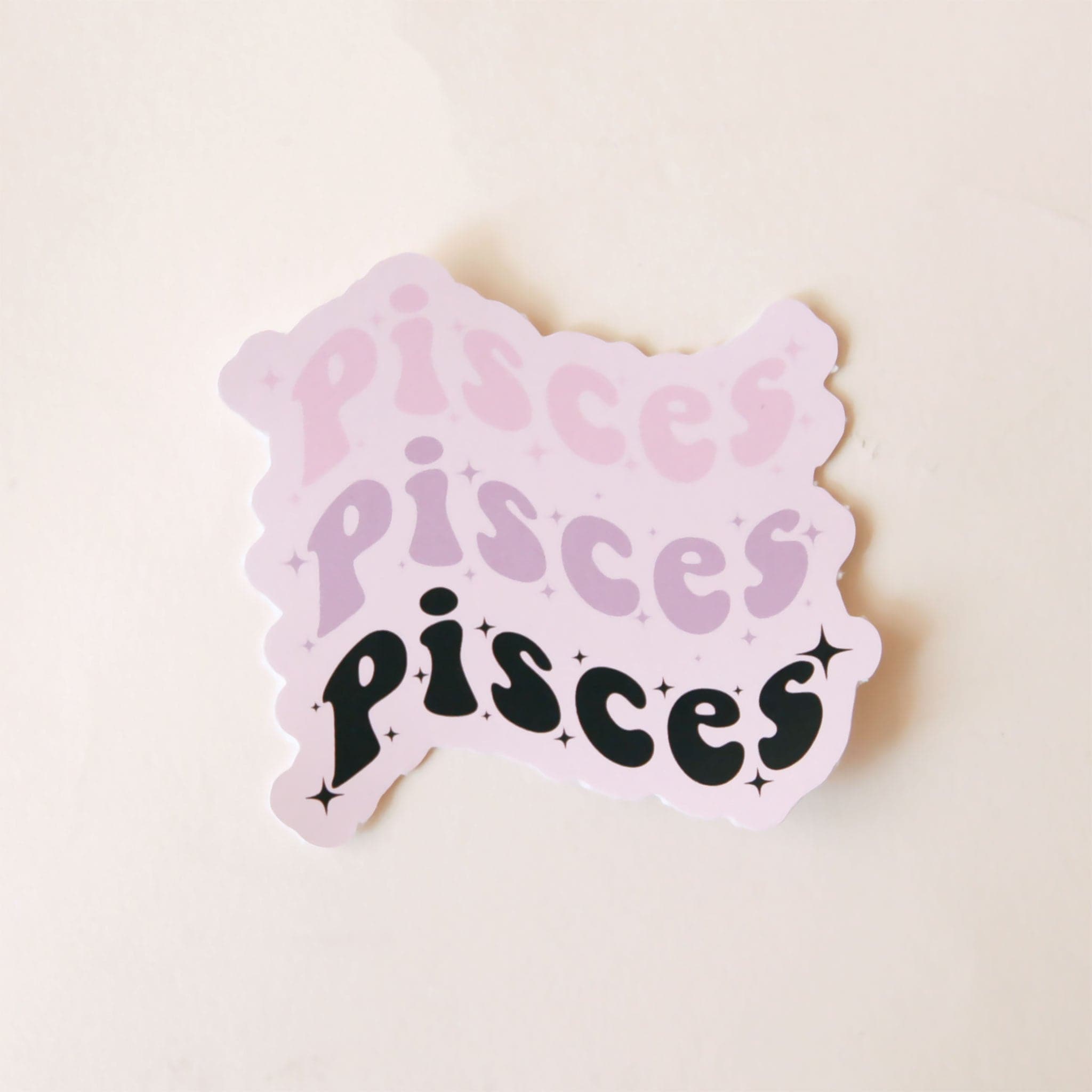 On a white background is a sticker with the word &quot;Pisces&quot; stacked on top of one another in a wavy design. 