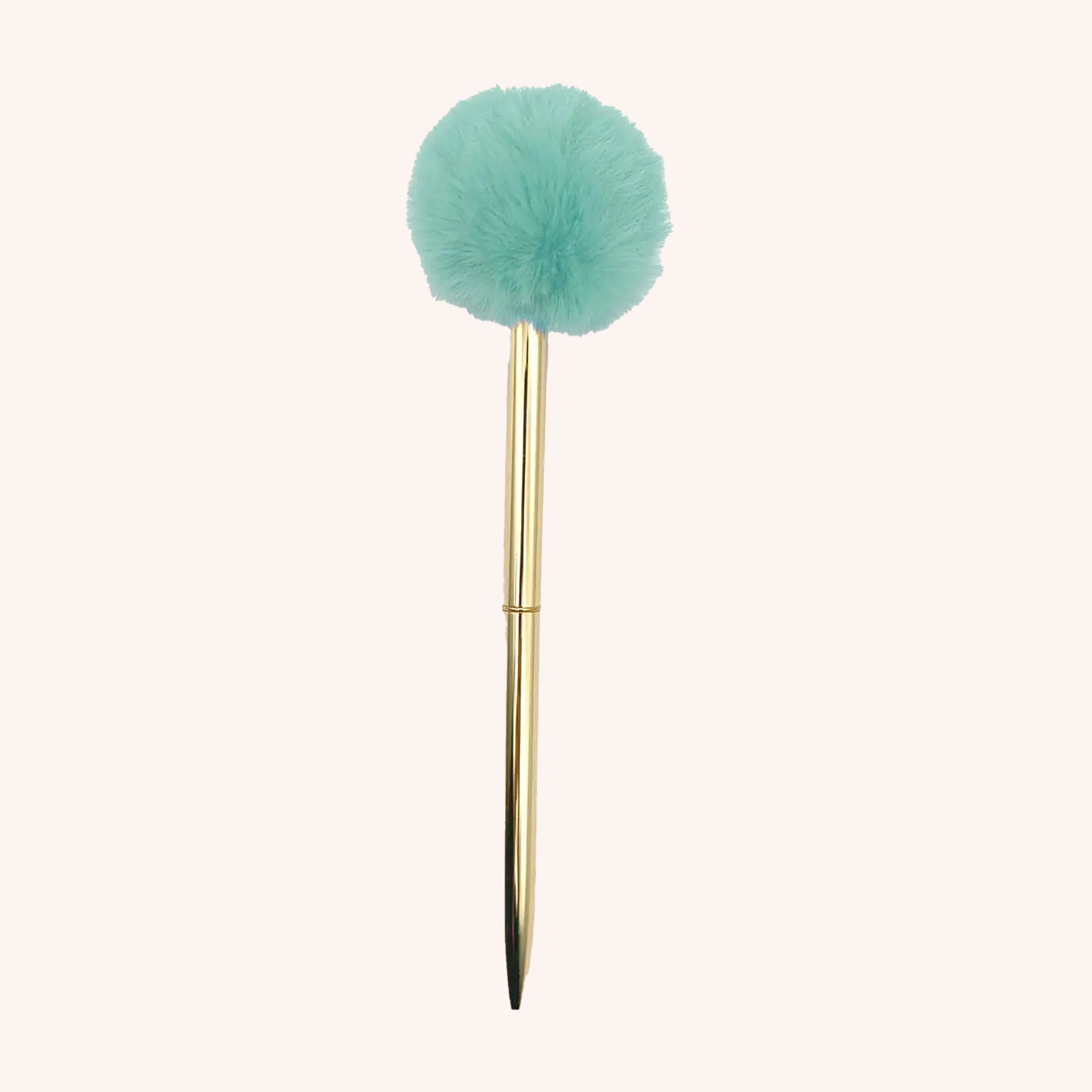 A thin gold pen with a fluffy mint green pom pom at the end. 