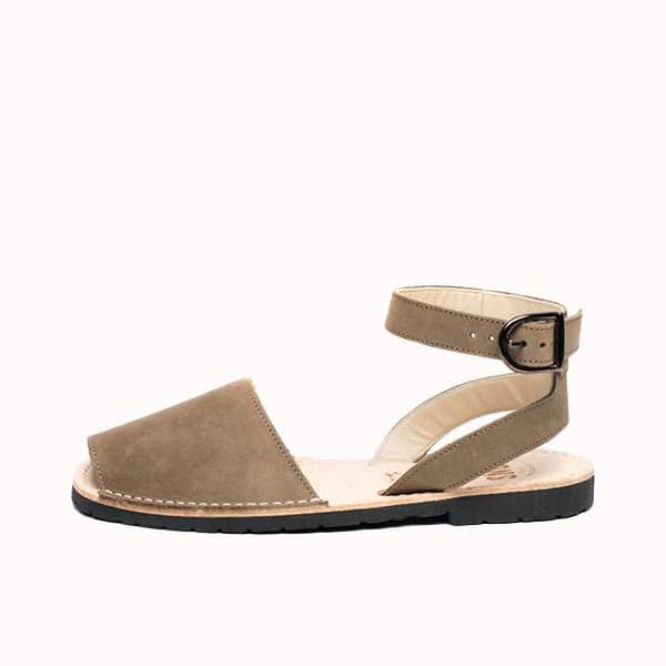 Single Avarca sandal made of lightweight rubber molded to a light natural leather sole. The sandal&#39;s front strap is taupe toned and large enough to cover the front half of foot. Above is a thin leather ankle strap with a buckle closure. 