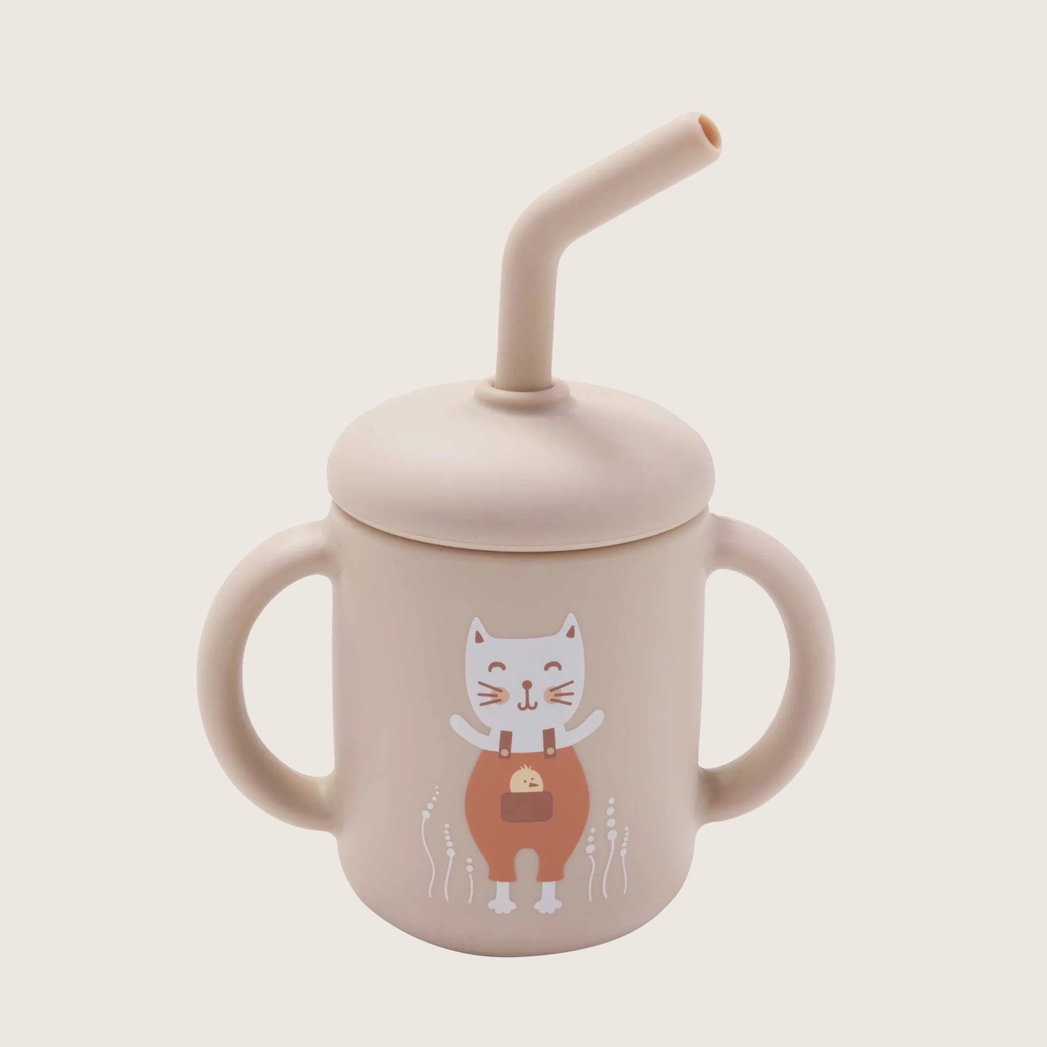 On a cream background is a light pink sippy cup with two handles and straw, designed with a white kitten illustration on the front. 