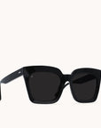 Sedona framed sunglasses with glossy black arms and frames made of high quality acetate. These glasses have a distinct, oversized look from their thick frames and round, squared and dark lenses.