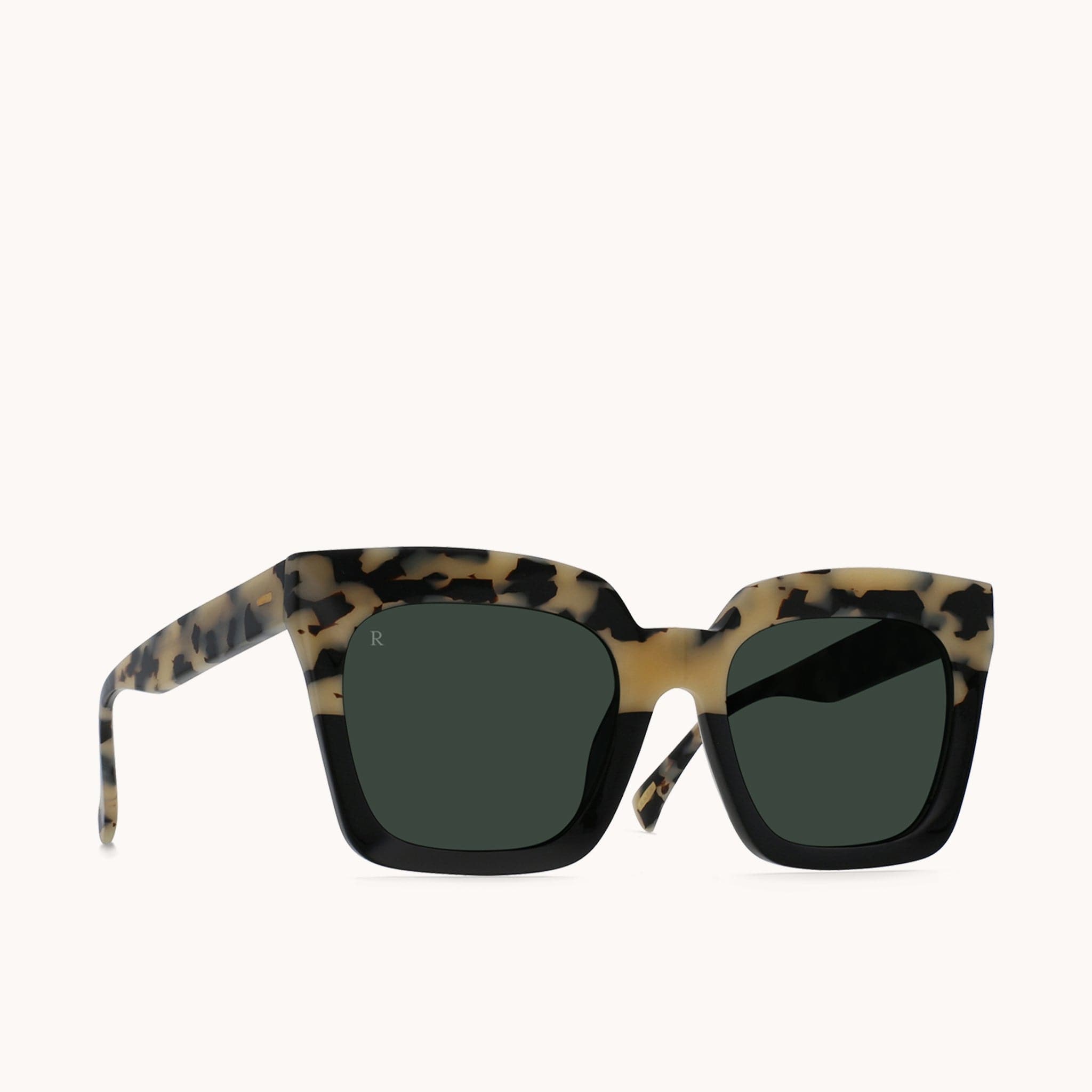 Sedona framed sunglasses with two-toned tortoise and solid black frames made of high quality acetate. The arms are a tortoise print of the same material. These glasses have a distinct, oversized look from their thick frames and round, squared and dark smoke toned lenses.