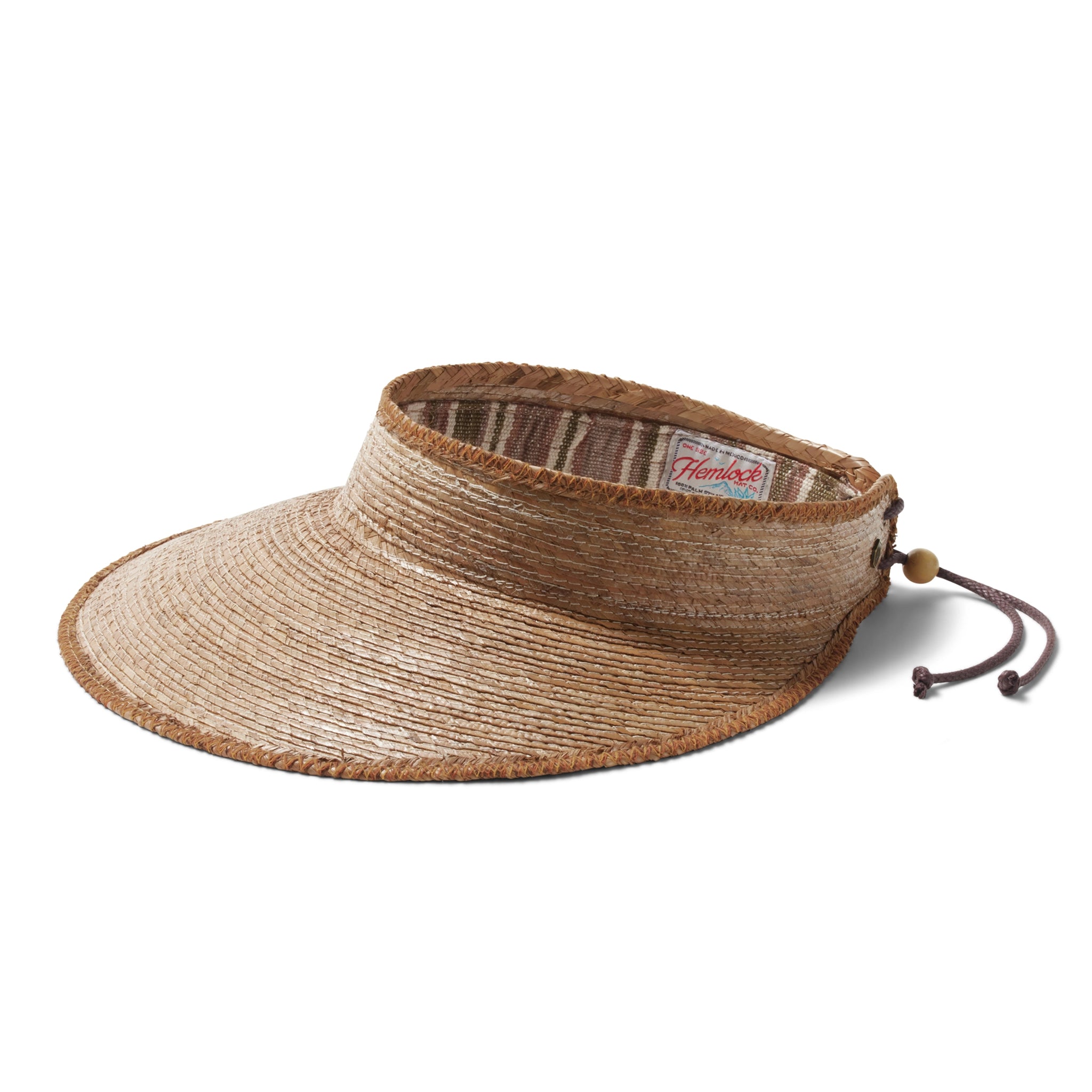 A woven straw visor hat with a large brim and beaded slip knot tie on the back that is adjustable, worn here on a model wearing a tank top and tan pants in front of a white background.