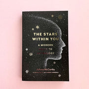 Black soft cover book featuring a silhouette of a face formed of stars titled 'the stars within you' in gold foil lettering. below reads 'A modern guide to astrology'. A sky filled with both twinkling and shooting stars fills the background. 