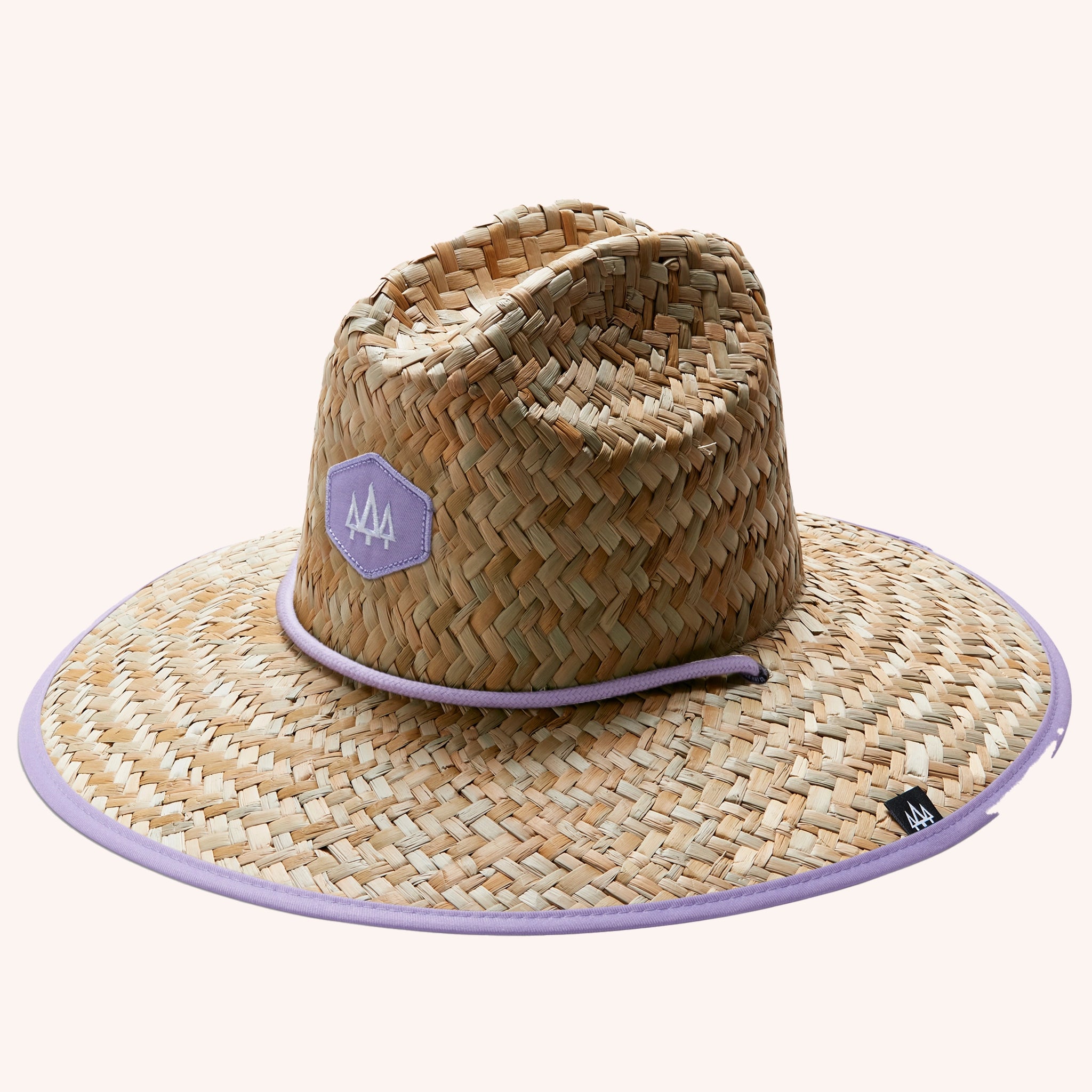 A woven straw sun set with a wide brim, a light purple drawstring and purple detailing underneath the brim of the hat as well as on the center label.