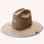 A woven straw sun set with a wide brim, a light purple drawstring and purple detailing underneath the brim of the hat as well as on the center label.