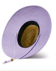 A woven straw sun set with a wide brim, a light purple drawstring and purple detailing underneath the brim of the hat as well as on the center label.