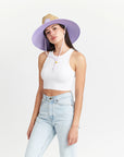 A woven straw sun set with a wide brim, a light purple drawstring and purple detailing underneath the brim of the hat as well as on the center label.