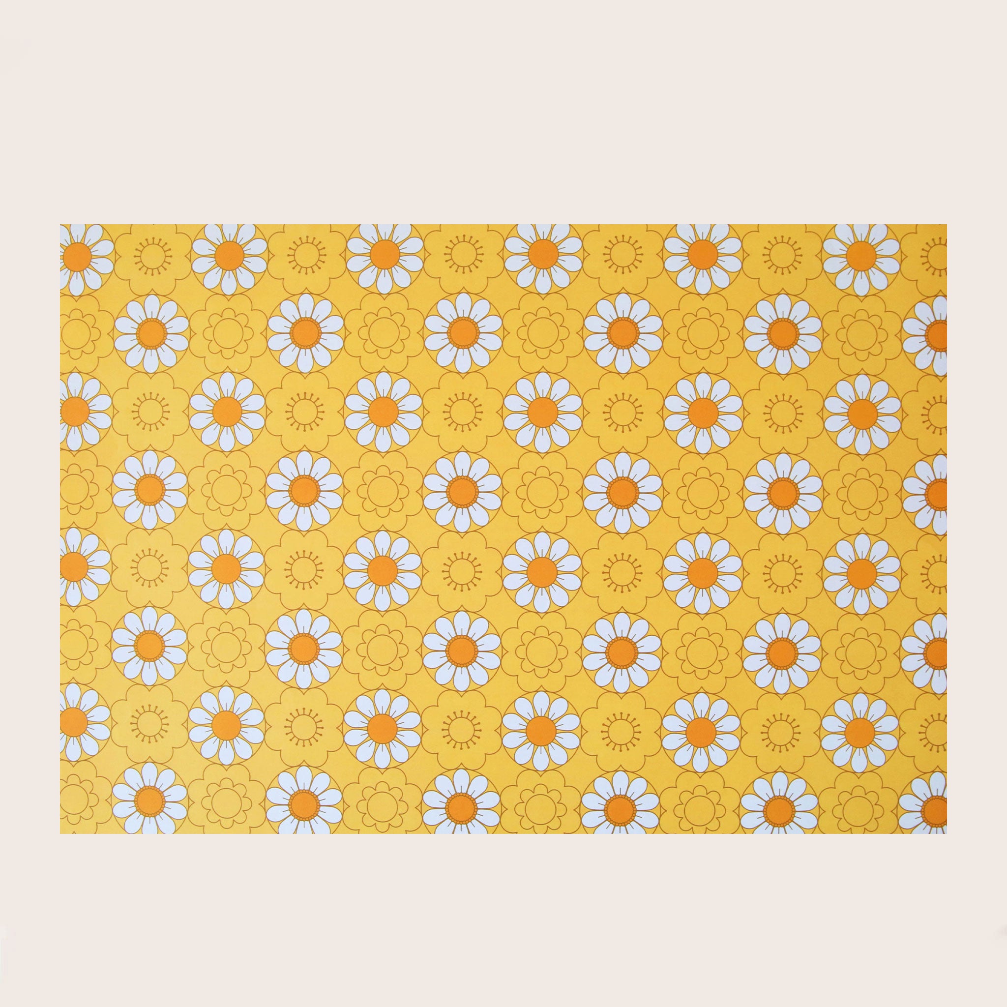 A wrapping paper featuring a yellow base and a white and orange daisy pattern all over. 