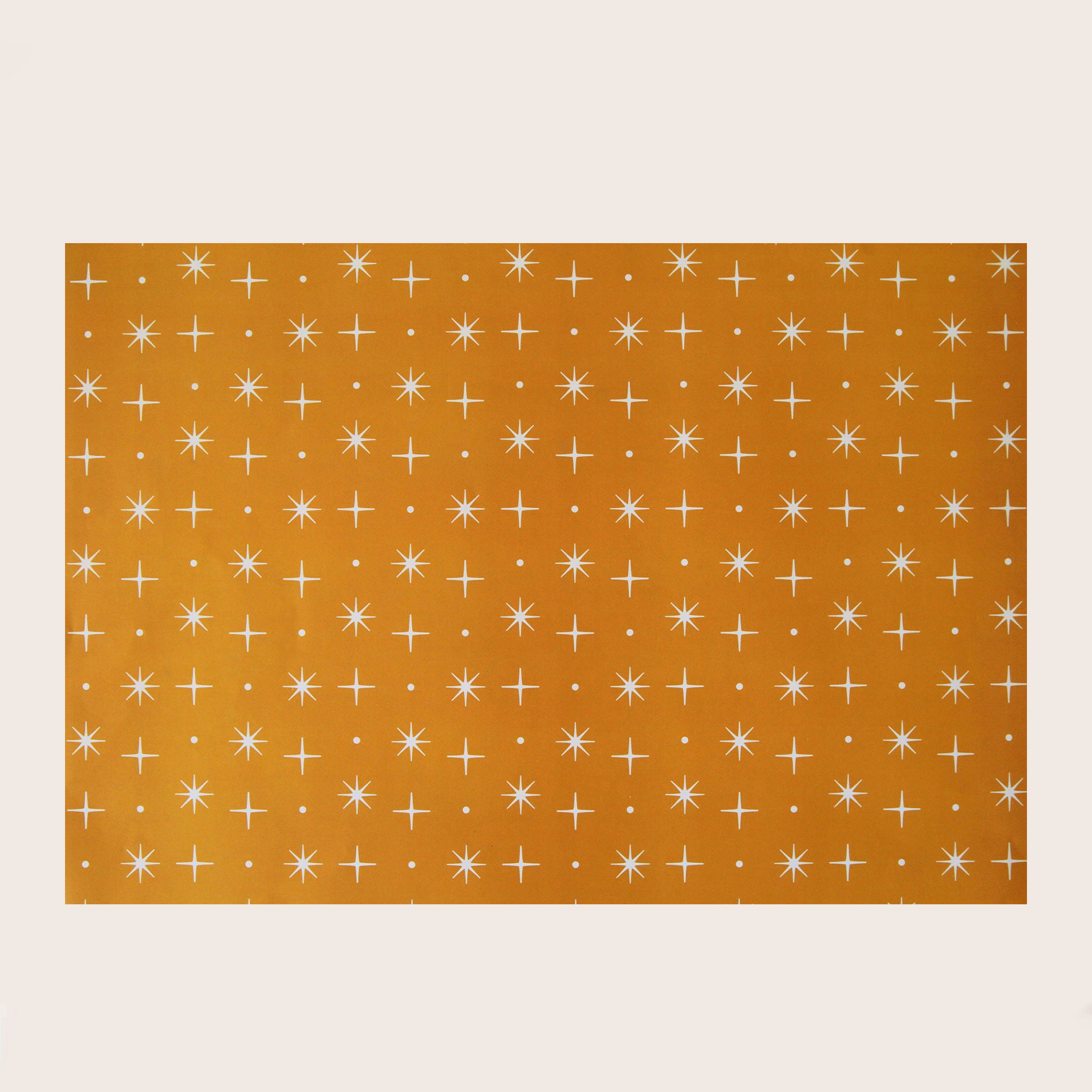 A single sheet of gift wrap featuring a mustard yellow background with a repeating white star design. On the flip side, you have the option of a cream background with groovy vehicles including vintage inspired RV's, and VW bugs and buses.