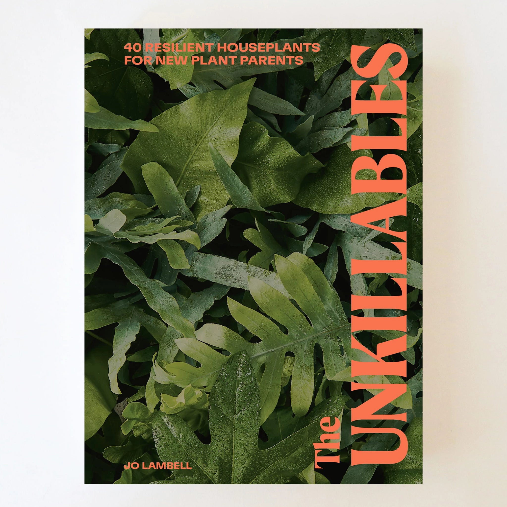 A book cover filled with a photograph of green leafy house plants and orange text on the side that reads "The Unkillables, 40 resilient houseplants for new plant parents".