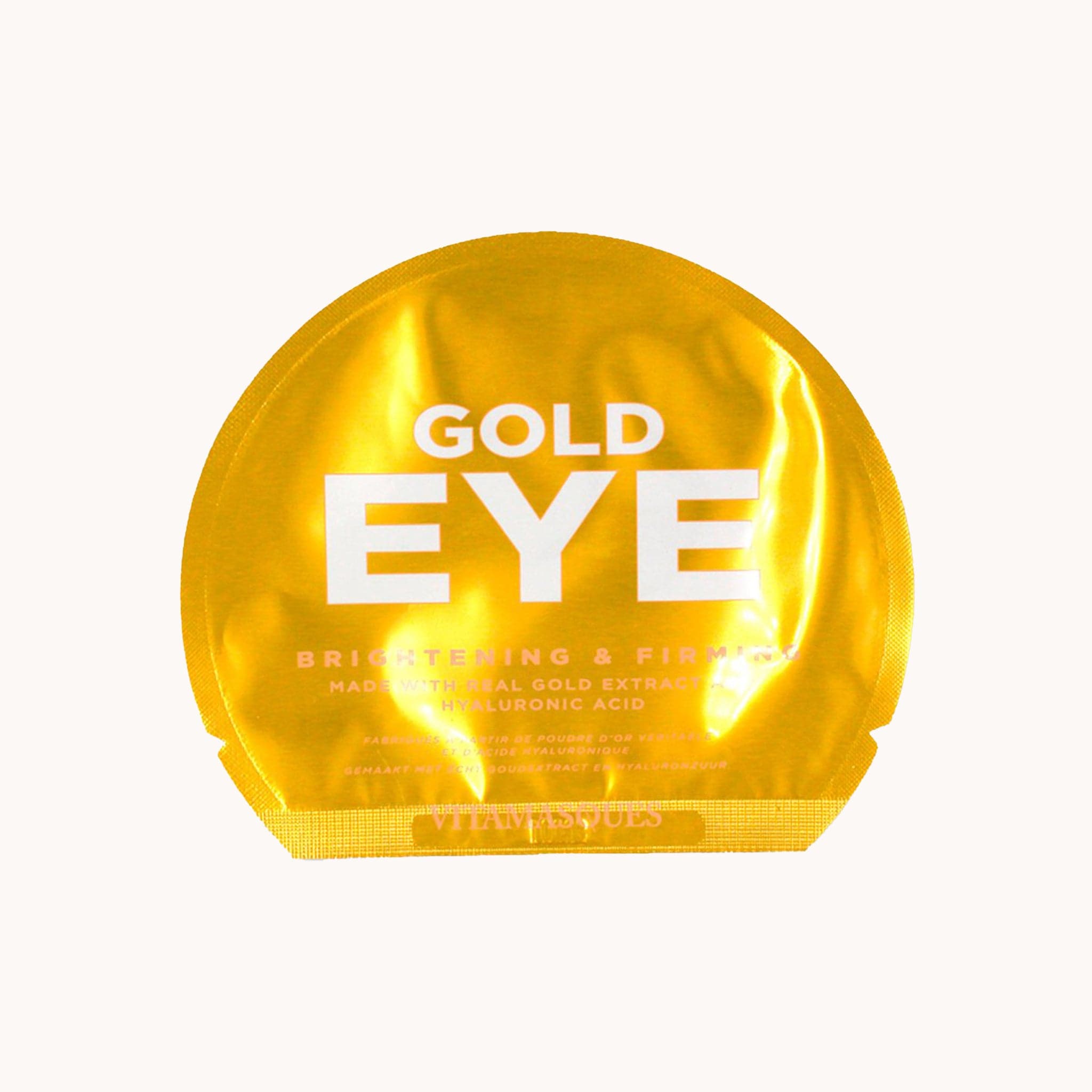 A packet of eye patches in a bright gold arched packaging with white text on the front that reads, "Gold Eye Brightening & Firming".