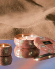 The Kalahari collection shown together with the mini tin and 3-wick tin. Its colors are beautiful and the jar's tin distributes light in a romantic way. Edit alt text