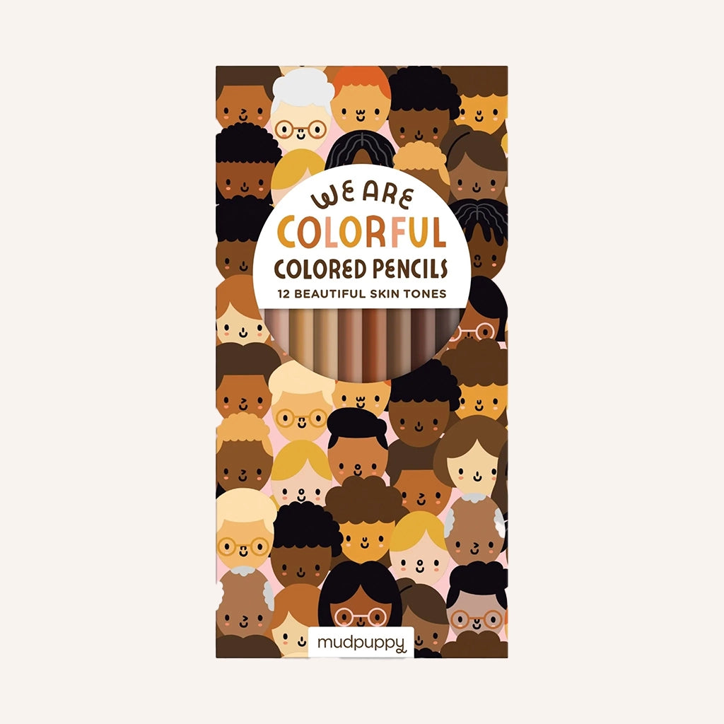 A box of 12 skin-toned colored pencils in a cardboard box with a graphic design illustrating smiling faces of people of all different skin-tones.
