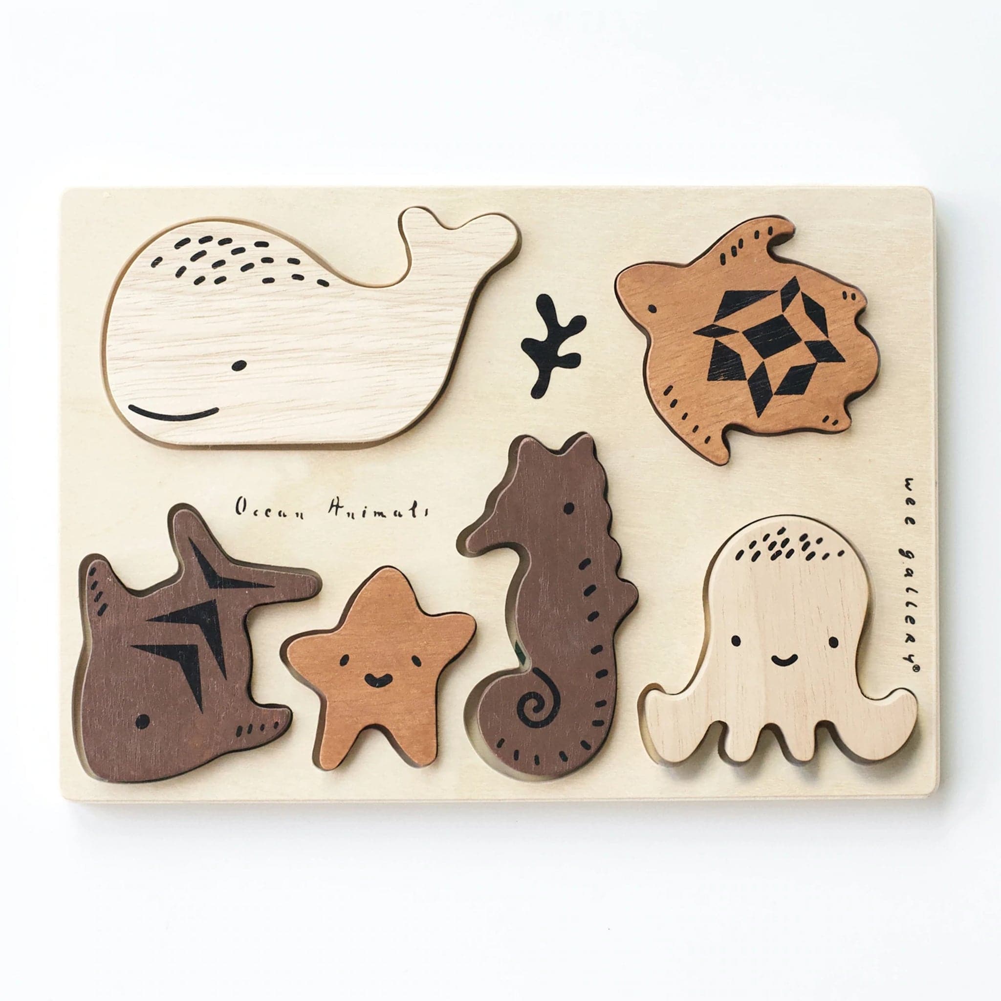 Sweet sea creatures scattered around their puzzle board. There is a starfish, octopus, sea horse, turtle, fish, and whale. Each puzzle piece is wooden and a different color wood. There are shapes matching each creature for a little one to fit perfectly in.