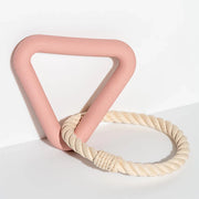 A triangle pink rubber toy with a circle rope toy linked on the other end.